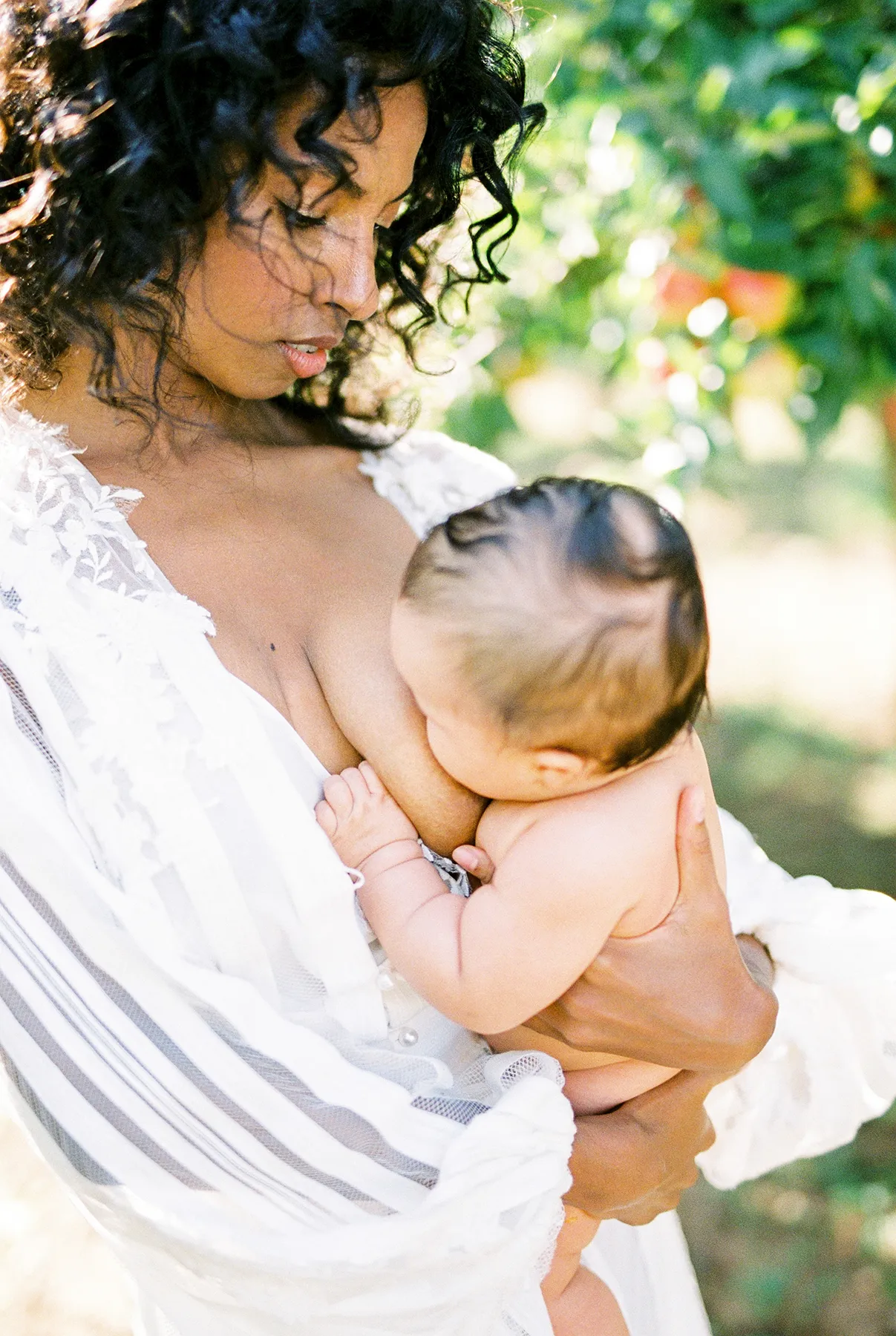 woman-breastfeeding-her-newborn-baby-in-the-garden-2025-01-07-20-07-30-utc